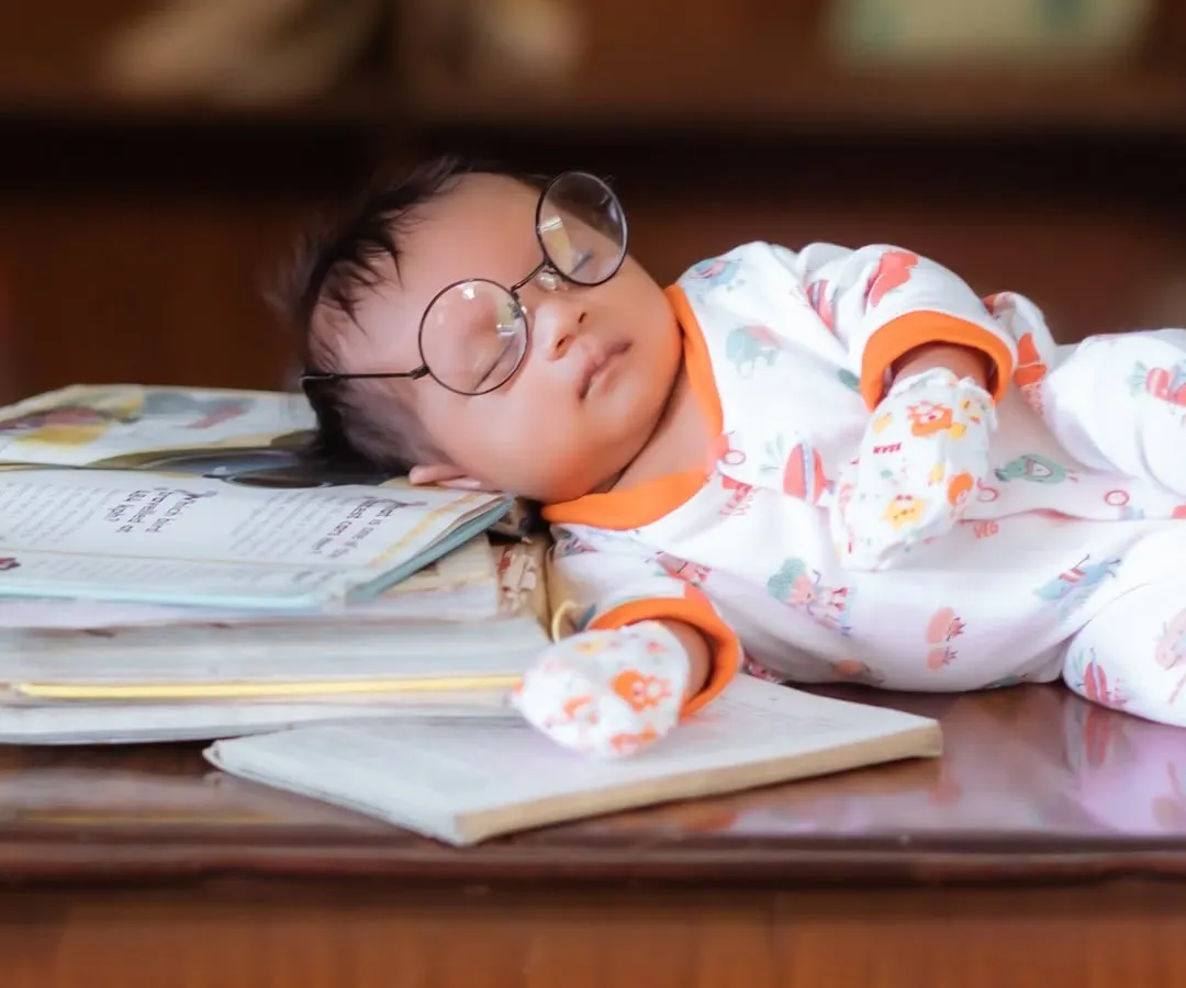 Even the tiniest scholars need a nap. This creative newborn portrait showcases how I use simple, charming props like these glasses to create a unique and memorable image.