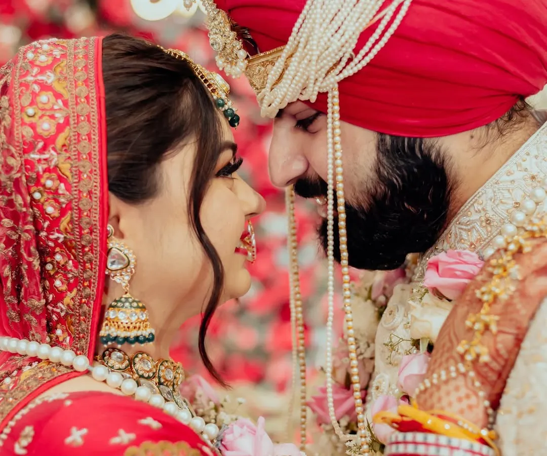 In the quiet moments before the world sees you as one, we find the purest expressions of love. This intimate close-up captures the unspoken promises and deep affection between a bride and groom, their faces close, lost in their own world.