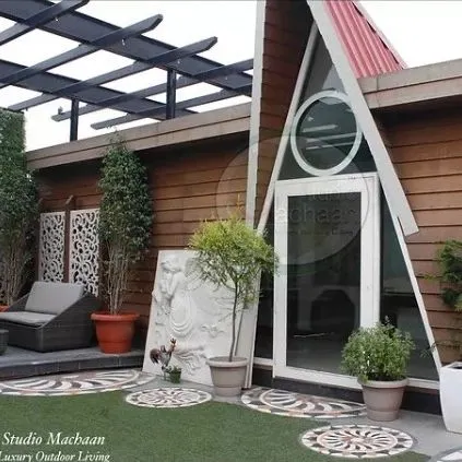 This A-frame prefabricated cabin is one of my signature designs for turning a terrace into a statement. Its unique shape creates a spacious, light-filled room, while the wood-cladding and glass facade blend modern architecture with natural elements.