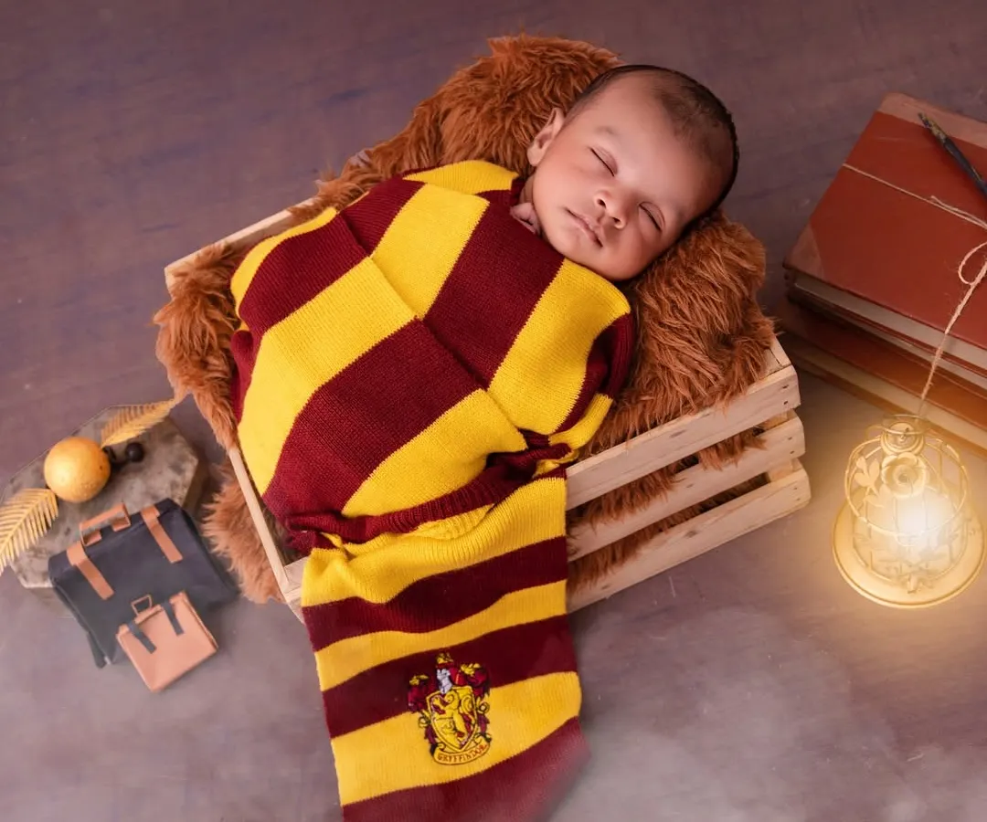 For a classic newborn look with a magical twist, I pose sleeping babies in this cozy Harry Potter theme. This shot captures the peacefulness of your newborn while celebrating a story you love, using soft wraps and safe posing techniques.
