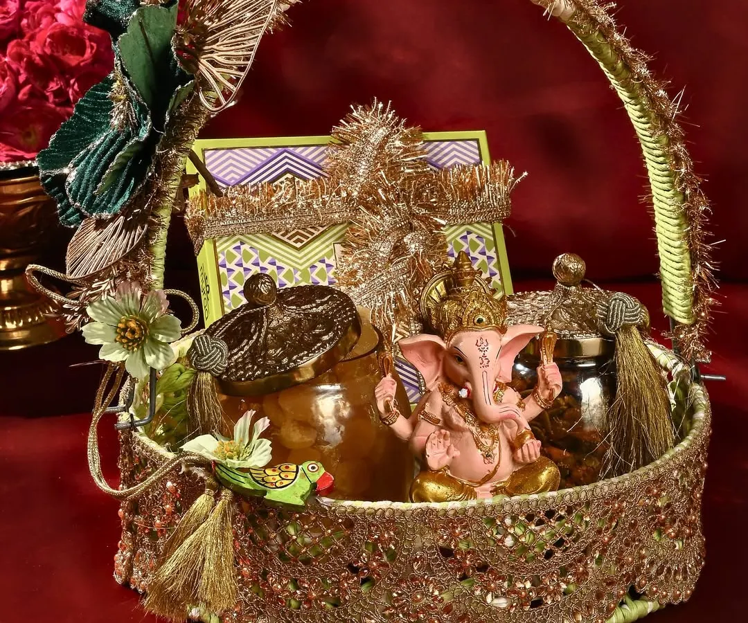 This is one of my favourite creations for Ganesh Chaturthi. This ornate basket is filled with traditional treats, including a hand-painted Ganesha idol, making it a complete and auspicious offering for the festival.