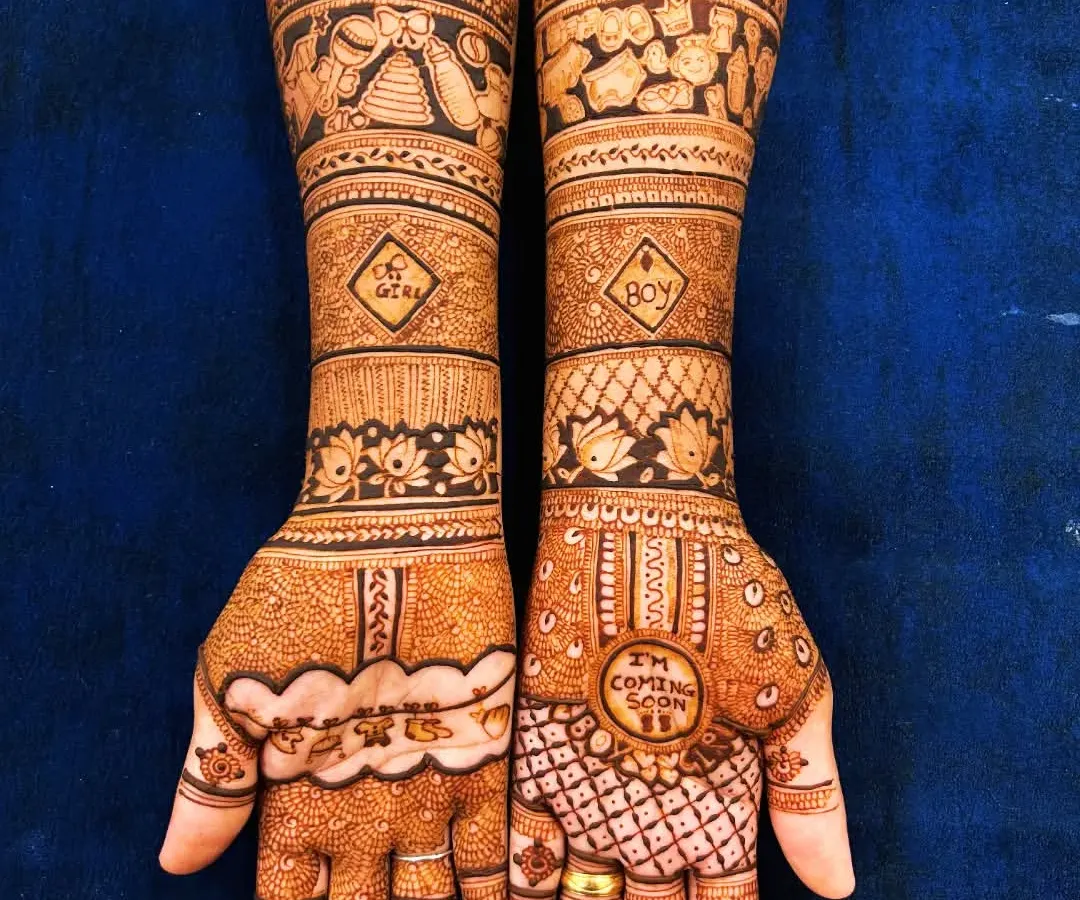 Celebrating the journey to motherhood with a custom baby shower mehendi. This design includes playful elements like "Mom," "Dad," and baby toys, making it a truly personal piece.