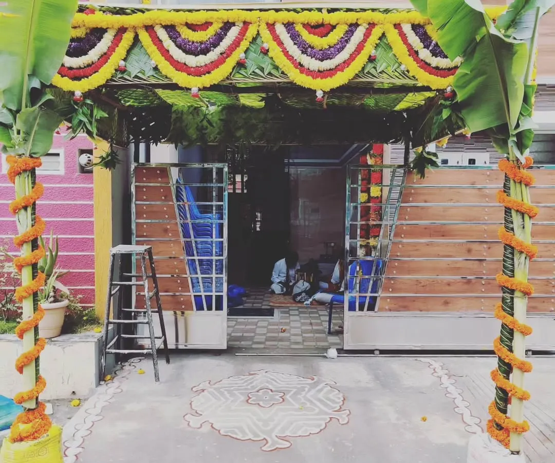 For a traditional housewarming, or Gruhapravesam, we create an authentic and auspicious entrance. This setup features a pandal made with coconut leaves, fresh banana plants, and marigold flower garlands for a truly blessed welcome.