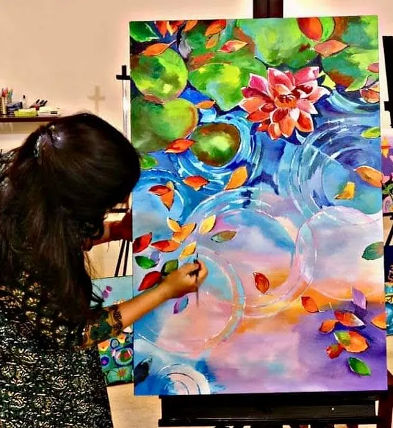 It's never too late to find your inner artist. This student is creating a beautiful, vibrant lotus pond painting, finding her moment of peace and focus in my adult art class.