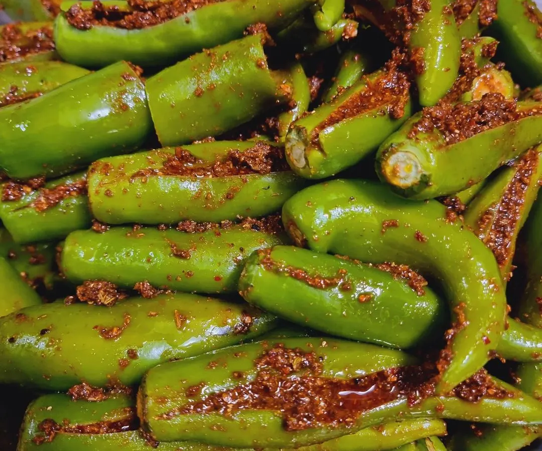 This is my Bharwa Hari Mirch achaar. I carefully stuff each fresh green chili with a flavourful masala mix that is spicy but not overpowering. It's a real treat for those who love a bit of heat.