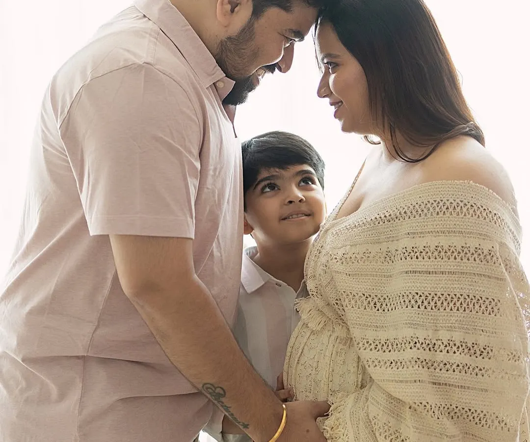 There is a sacred stillness when a family pauses to listen. Here, a big brother-to-be looks up with wonder as his parents share a quiet moment, their heads bowed together in love and anticipation. These natural light family maternity sessions are about capturing the connections that are already there.