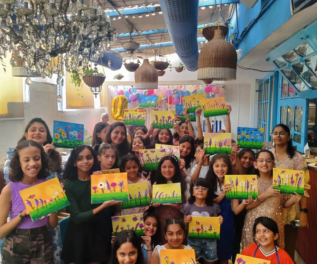 The pure joy of a kids' birthday party. A large group of young artists proudly display the vibrant floral canvases they created. This is what it's all about: fun, friendship, and a masterpiece to take home.