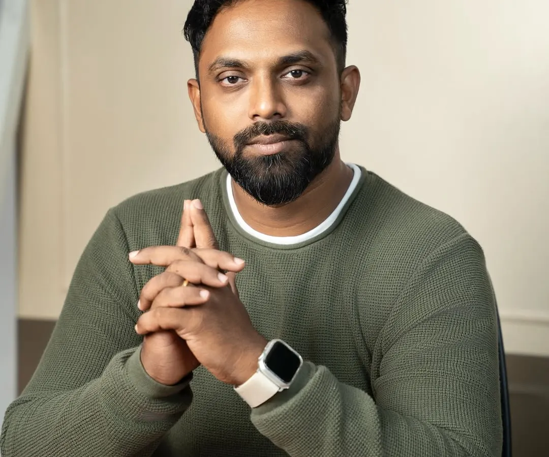 A clean and confident professional headshot, perfect for making a strong impression on LinkedIn or a company website. The focus here is on approachability and professionalism, achieved with simple studio lighting and a relaxed, direct-to-camera pose.