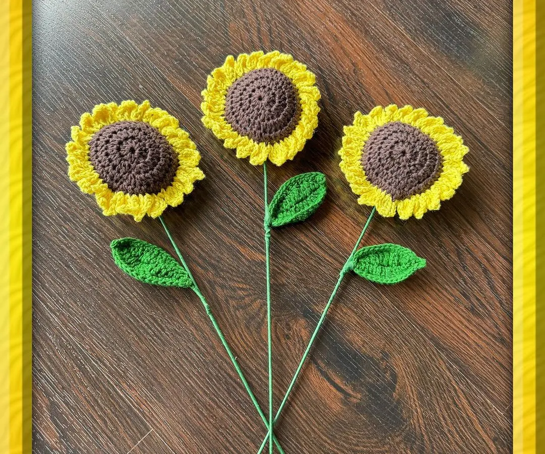 Here are three of my single-stem crochet sunflowers, each crafted with bright yellow petals and a detailed brown center. These are great for creating your own custom arrangement or as a simple, cheerful gift that won't wilt.