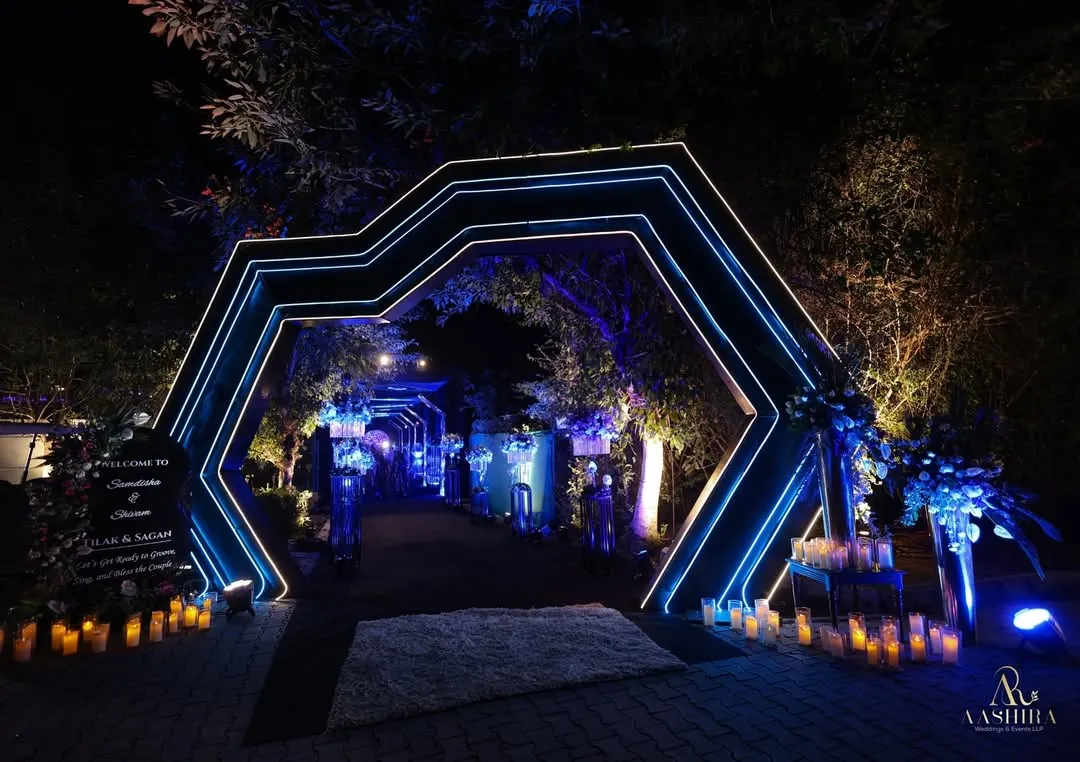 An entrance should be a portal to another world. For this modern cocktail event, I designed a series of geometric LED arches, bathing the walkway in electric blue light to build anticipation and create a dramatic, high-energy welcome for guests.