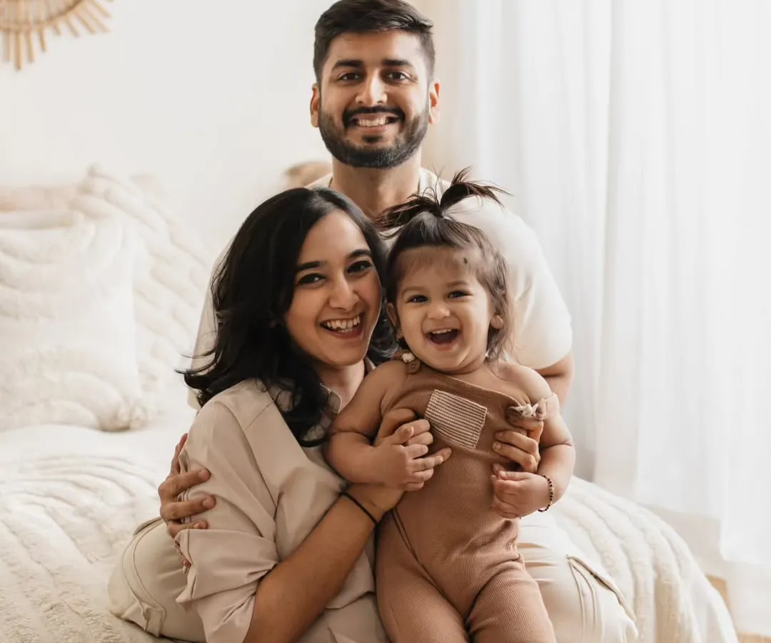 This is what pure joy looks like! I love capturing these candid, laughing moments during my family lifestyle sessions. This photo, taken in my boho-themed studio setup, shows how fun and relaxed a family photoshoot can be.