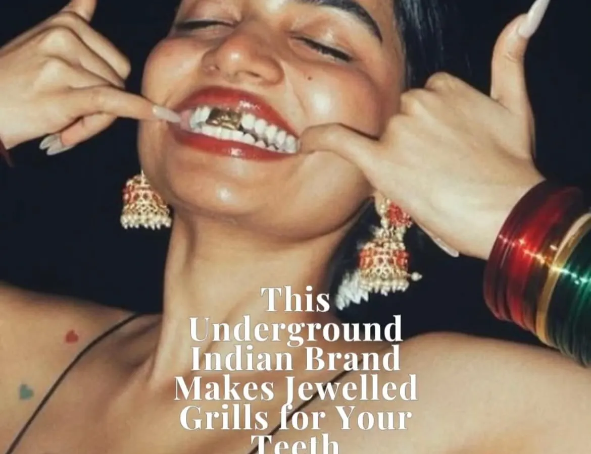 A close-up shot of a custom gold grill set, featured in The Word Magazine. This piece captures the vibe of Frostbite perfectly: bold, expressive, and rooted in a modern Indian aesthetic, complete with traditional jhumka earrings and a bindi.
