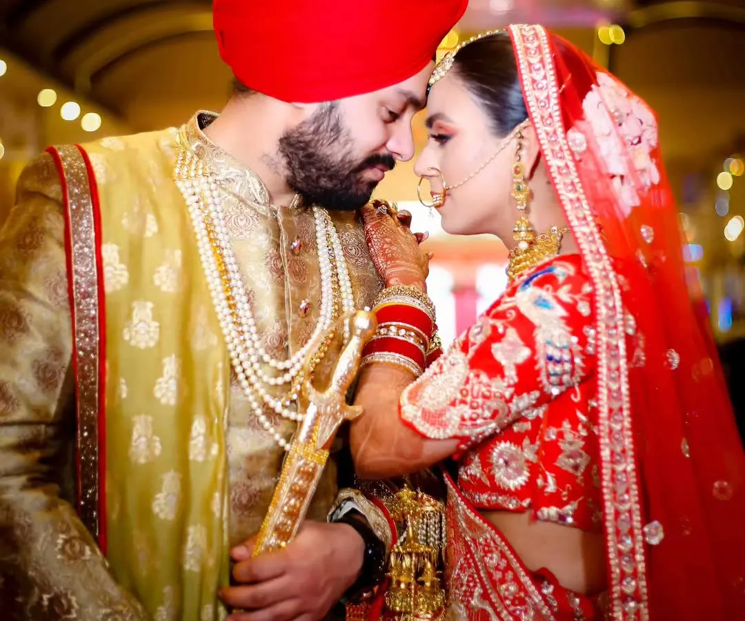 A quiet moment of connection on their wedding day. I love capturing the serene beauty of a Sikh wedding, focusing on the deep bond between the couple amidst the grandeur of the ceremony. This is a timeless portrait of love and faith.