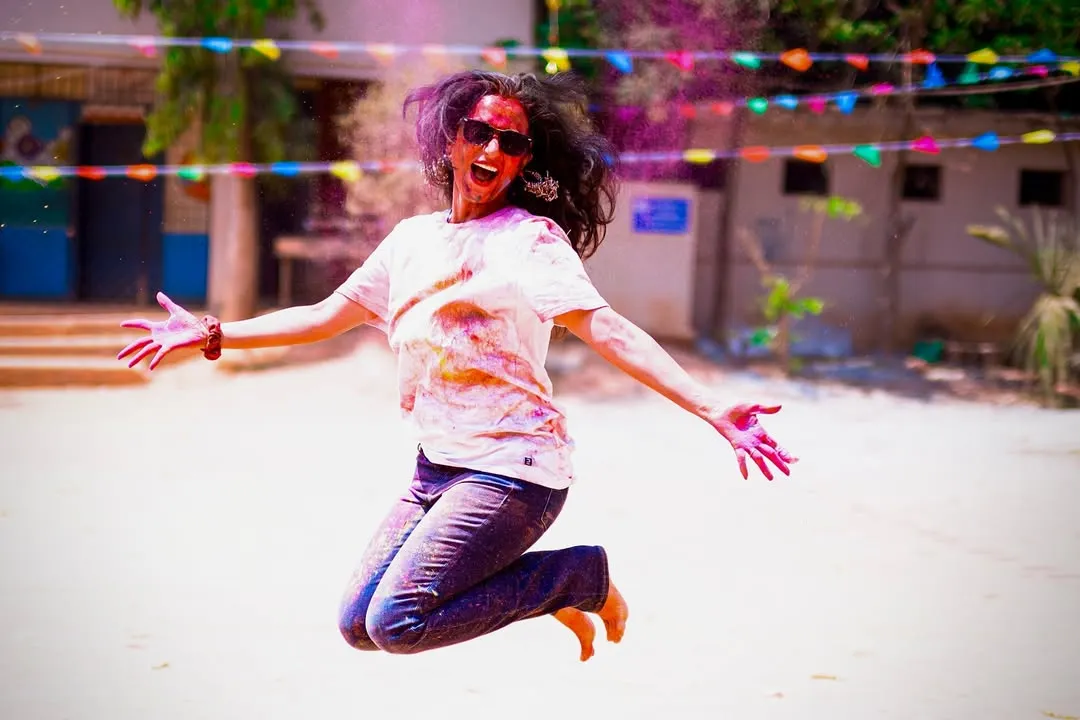 Jumping for joy during our Holi celebration. My classes are more than just a workout; they are a reason to celebrate life, get a little messy, and make unforgettable memories.