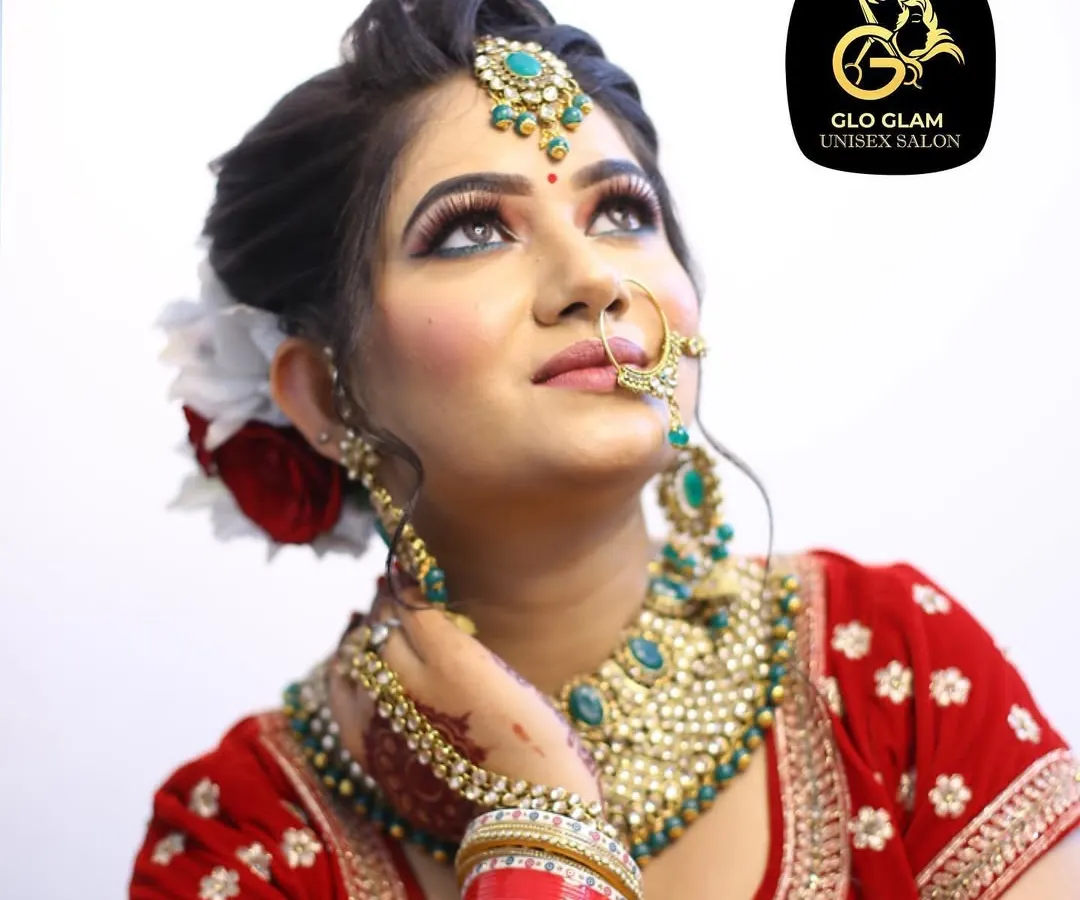 A close up of one of my brides, showcasing a classic Indian bridal makeup look. Notice the perfectly blended eyeshadow, sharp winged liner, and how the makeup complements her red lehenga and traditional jewellery for a timeless and elegant result.