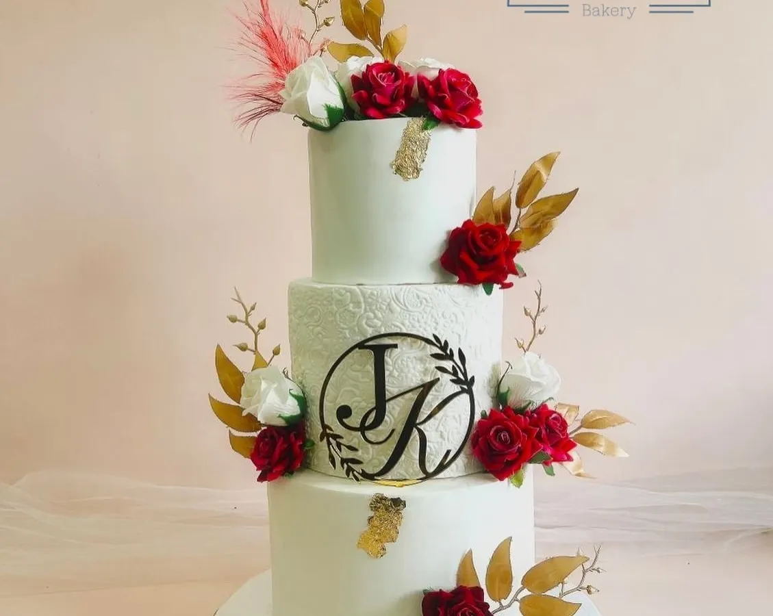 This is where elegance meets love. Our three-tiered wedding cake, personalized with the couple's initials and adorned with handcrafted red and white sugar roses, is designed to be the stunning centerpiece of your special day.