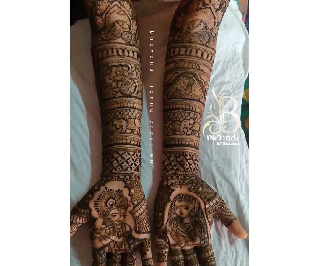 For a touch of divine love, I often create Radha-Krishna portraits. This design combines the classic spiritual motif with intricate patterns and traditional elements like elephants, covering the full arm for a complete bridal look.