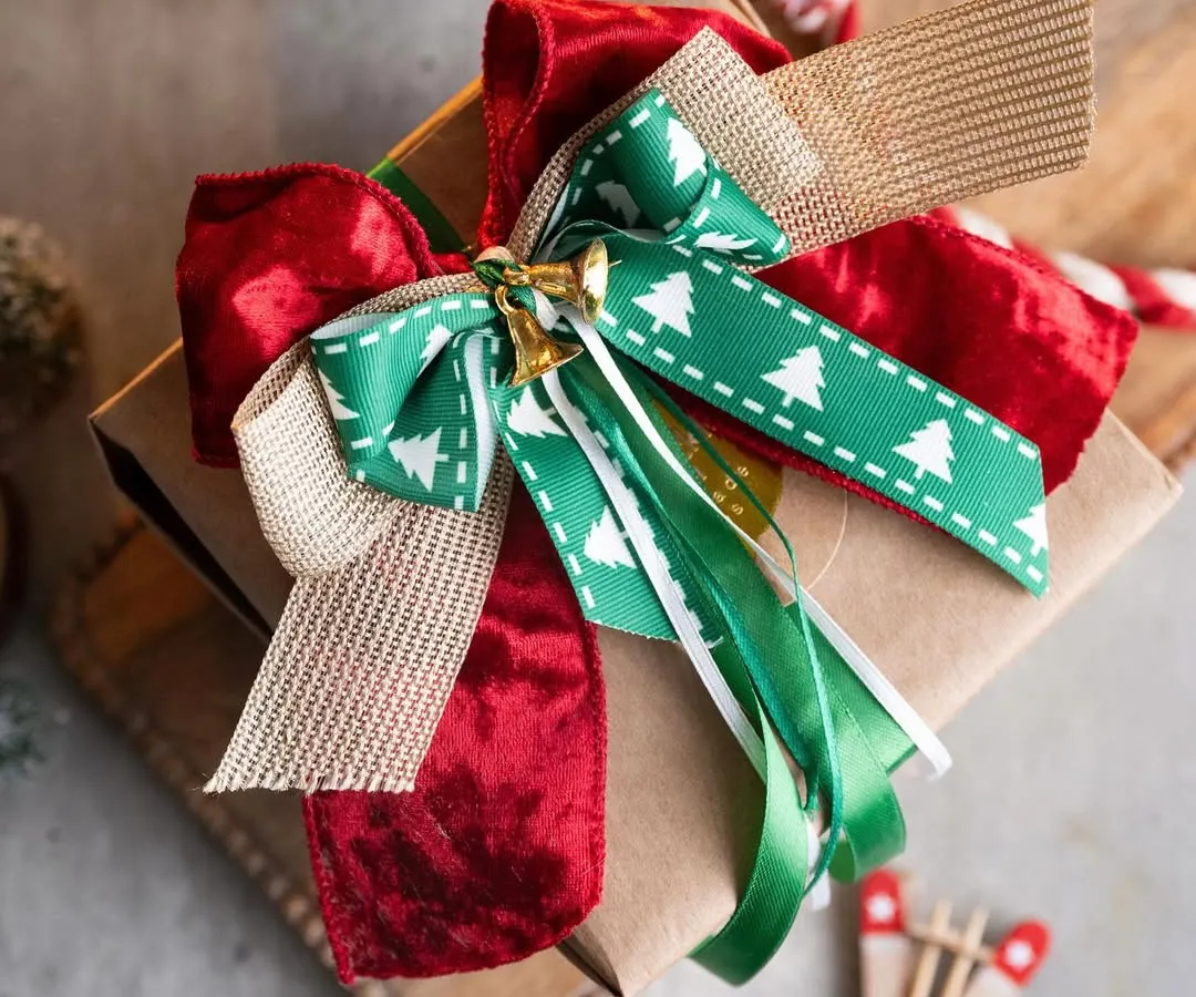 A beautifully wrapped gift is a joy to give and receive. This is an example of the kind of stunning, professional-level gift wrapping you can learn in my workshops, complete with layered bows and festive details.