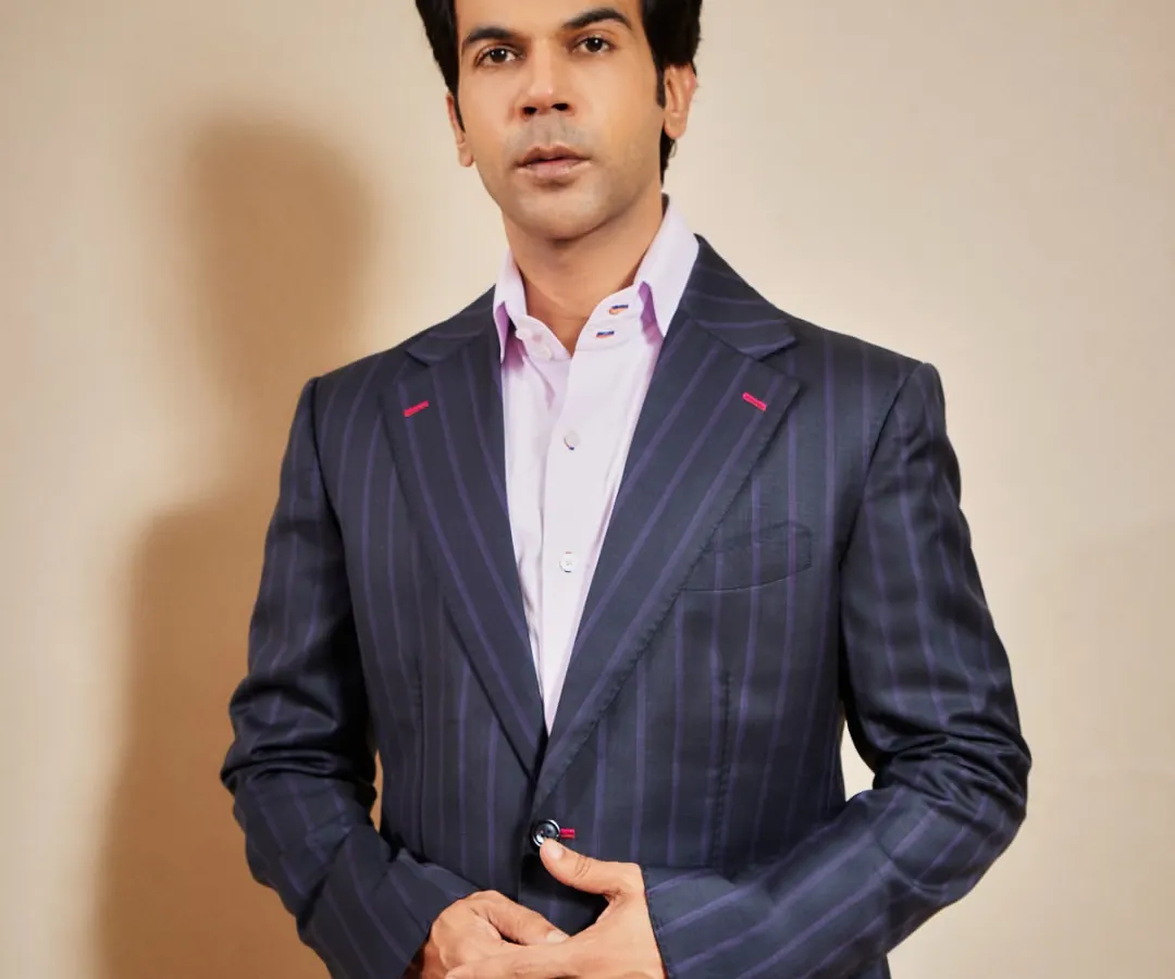 Actor Rajkummar Rao in a bespoke pinstripe suit. This highlights the core of my craft: impeccable tailoring that fits like a second skin, elevated by subtle details like the contrast red stitching on the buttonholes for a signature edge.