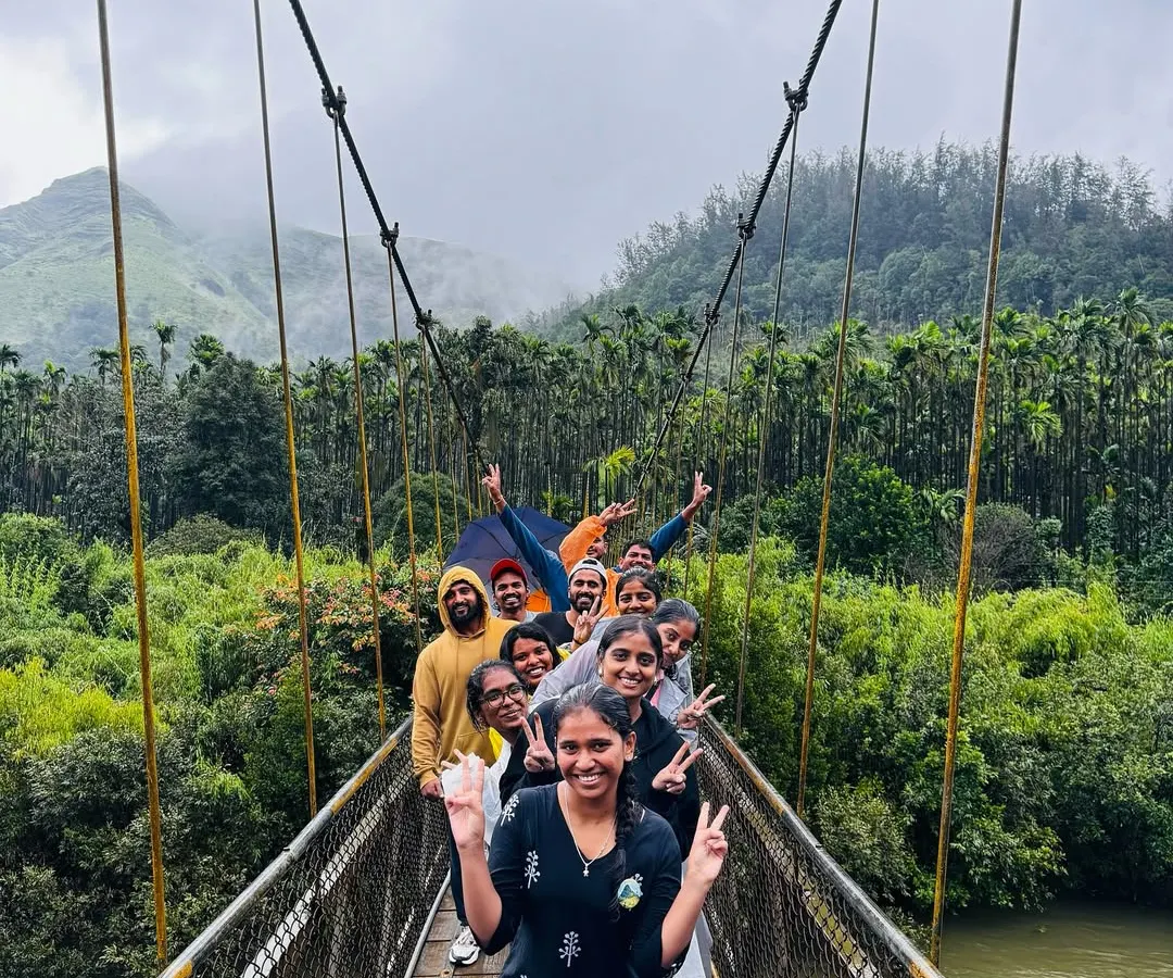 It's all about the journey and the people you share it with. Our group crossing a suspension bridge during the Kurinjal trek shows the fun, adventure, and teamwork that's part of every trip we organize.