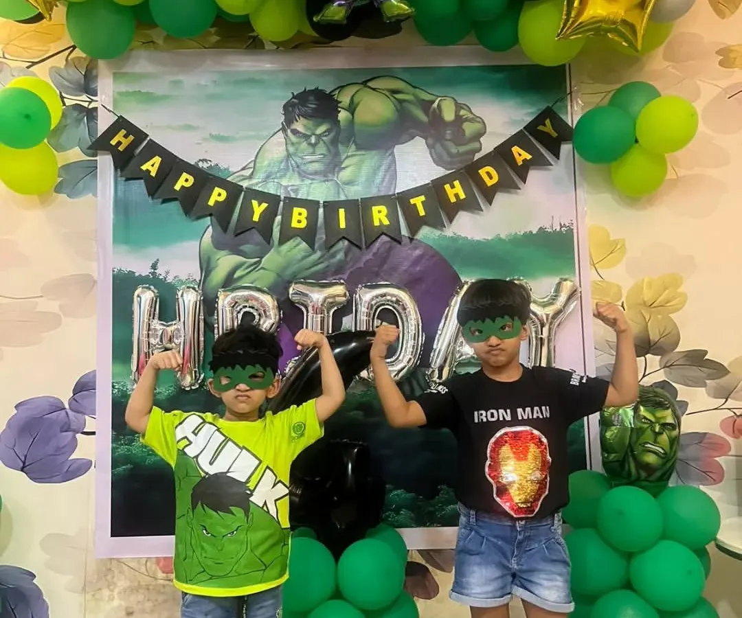 Look at these little superheroes enjoying their Hulk-themed birthday party. I created a full backdrop with a custom Hulk poster, a green and black balloon garland, and character foil balloons. Seeing the kids so happy and engaged with the decor is the best part of my job.