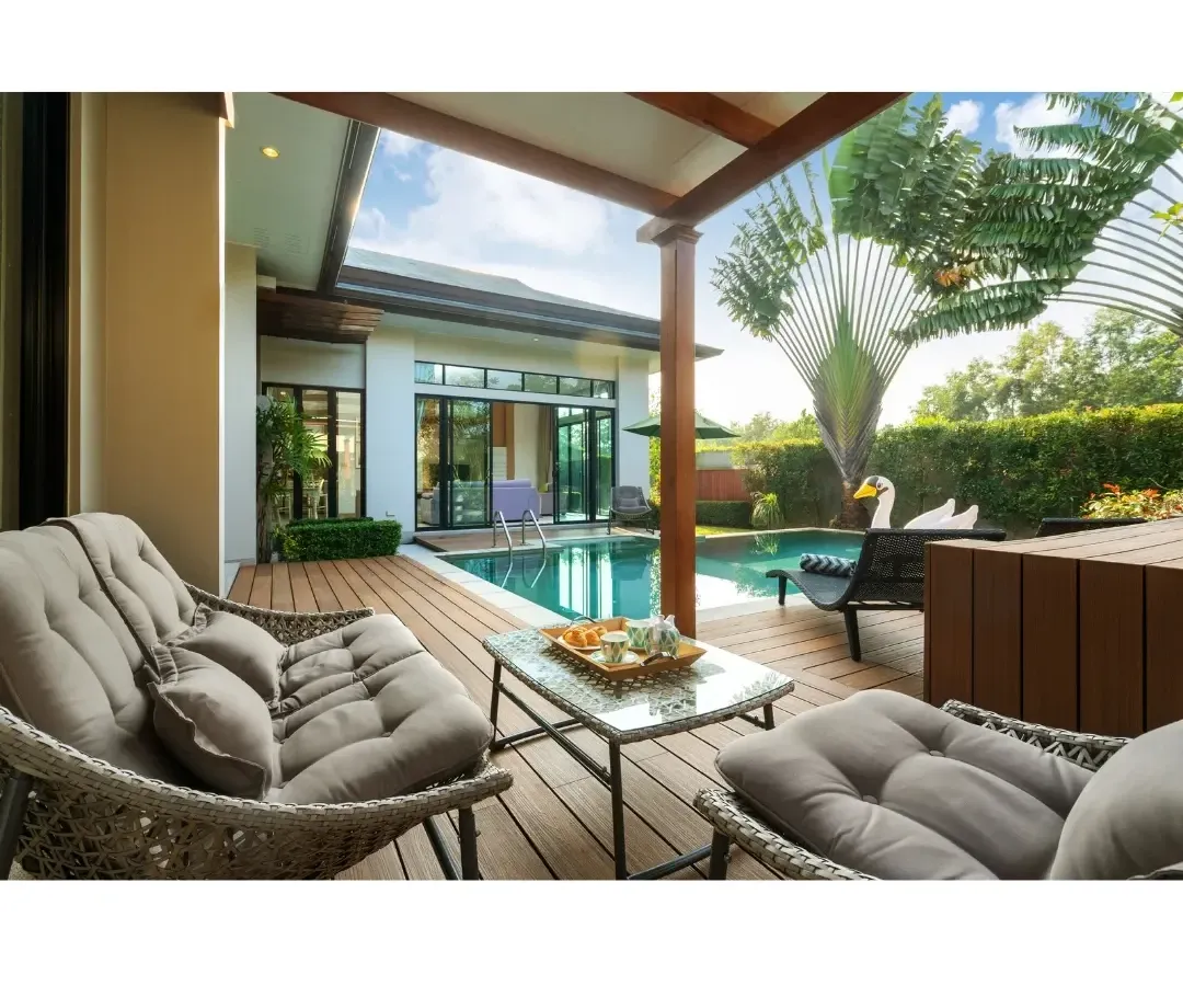 Imagine relaxing here. This poolside deck is made from Wood Plastic Composite (WPC), a fantastic material that gives you the look of wood without the constant maintenance. Paired with tropical plants like the Traveller's Palm, it creates a perfect, low-fuss luxury retreat right in your backyard.