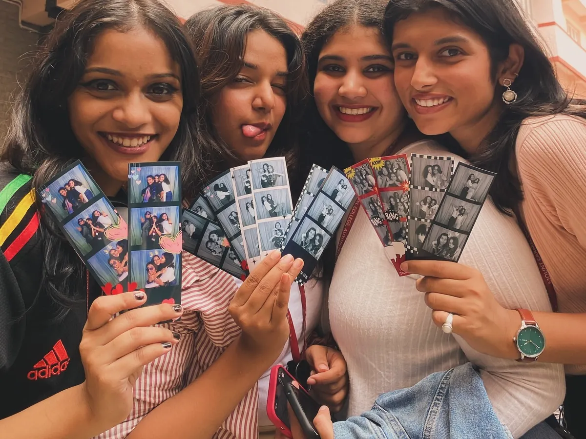 The pure joy of getting your photo strips! We love seeing groups of friends huddle together, laughing at the silly poses and fun moments they just captured. These instant prints are the perfect party favor that everyone gets to take home.