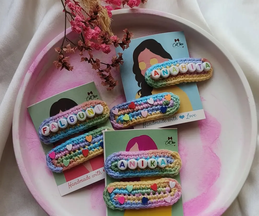 Our personalized name clips are one of our most-loved creations. We handcraft each one with colorful crochet yarn and letter beads to make a truly unique accessory for your little one.