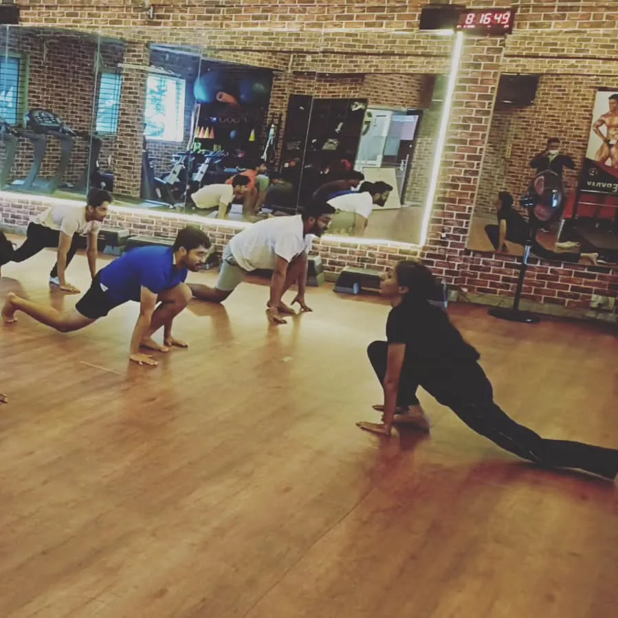 I guide my students through every movement. Here, we are in a deep low lunge, building strength and flexibility in a focused group setting.