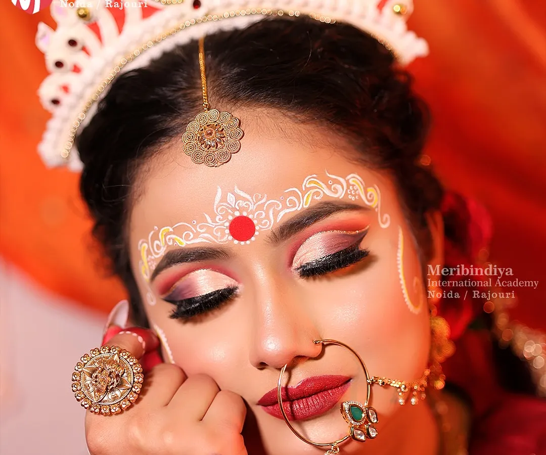 I will teach you the art of traditional Bengali bridal makeup, focusing on the iconic large, expressive eyes and the intricate 'Chandan' designs on the forehead that are central to this beautiful cultural look.