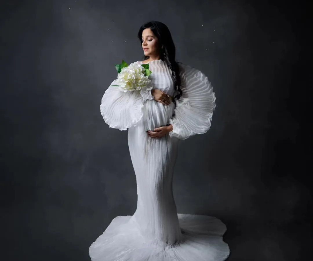 A portrait of strength, grace, and anticipation. In the studio, we use dramatic lighting and elegant gowns from my collection to create timeless images that celebrate your journey to motherhood.