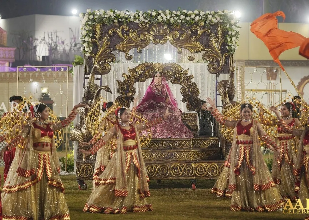 I believe a bride's entrance should be nothing short of majestic. Here, I crafted a royal arrival on an ornate palanquin, surrounded by dancers and a path of ethereal smoke, making her first appearance as a bride truly unforgettable.