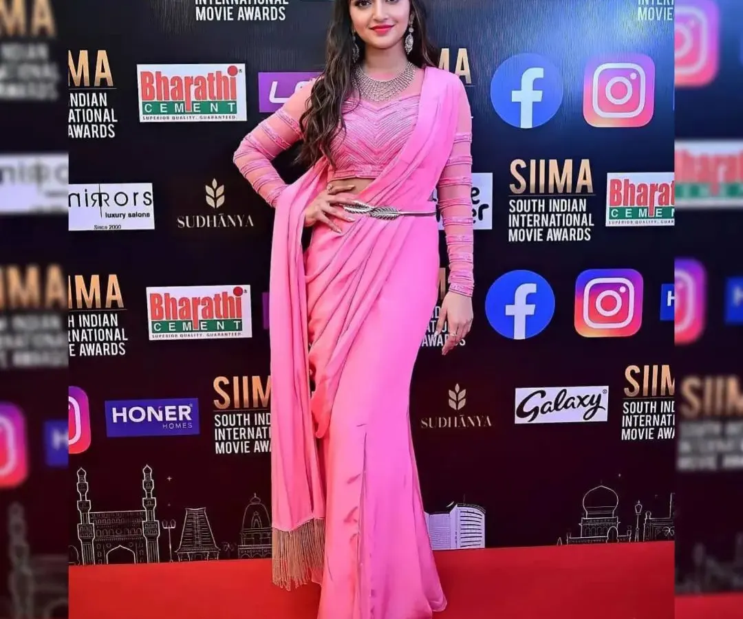 As seen on actress Sreeleela at the SIIMA Awards, this modern pink pre-draped saree offers effortless elegance. The sheer full sleeves and chic belt make it a perfect choice for award nights, receptions, or high-profile parties.