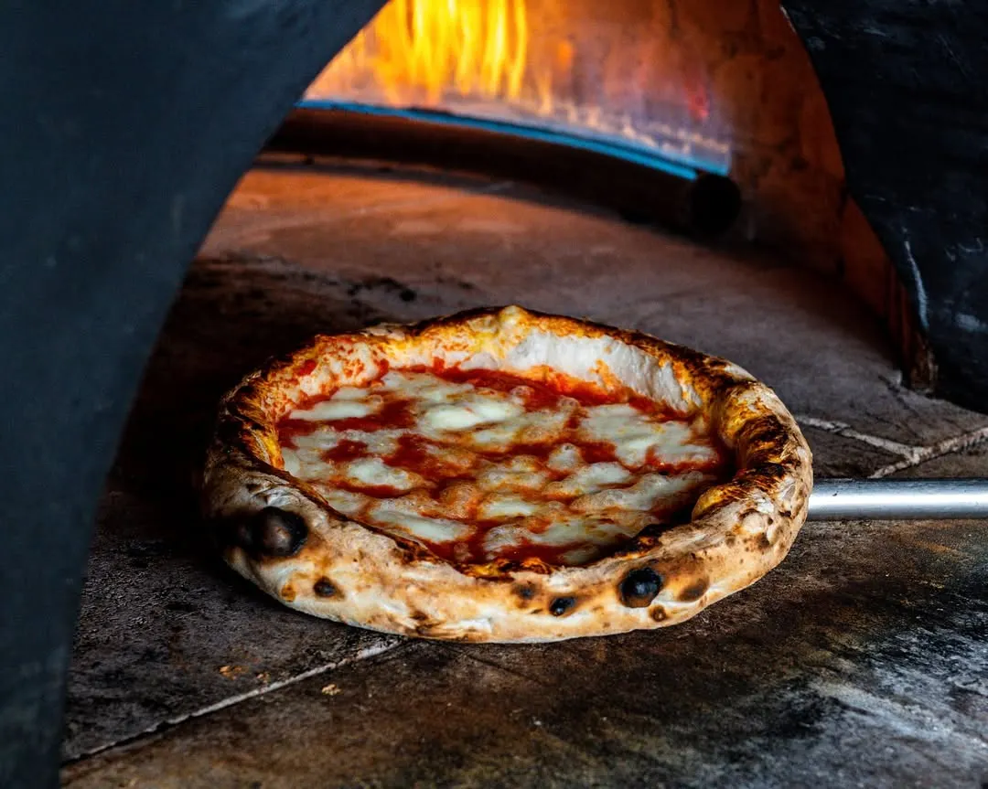 There's nothing like a pizza fresh from a wood-fired oven. I focused on capturing the intense heat, the perfectly charred crust, and the bubbling cheese to convey that unmatched flavor and authenticity.