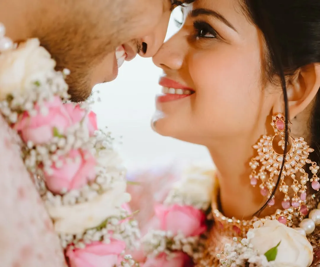 In the quiet moments, love speaks the loudest. This intimate close-up captures the pure joy and connection between a bride and groom, where a simple smile and gentle touch tell the entire story. I focus on these unscripted feelings to make your wedding album truly personal.