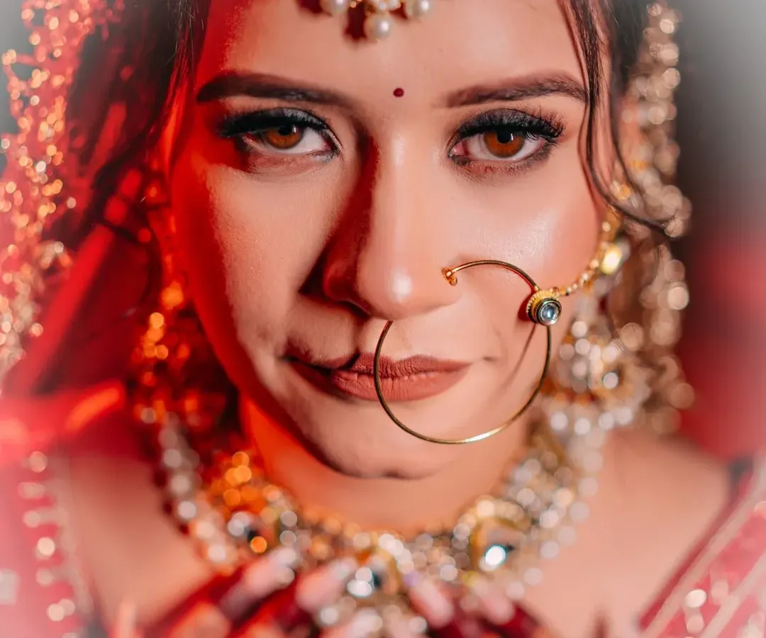 A bride's eyes tell a story of hope, love, and anticipation. I love creating intense, artistic bridal portraits like this one, using dramatic lighting to highlight the emotion and intricate details of the bridal jewellery and makeup.