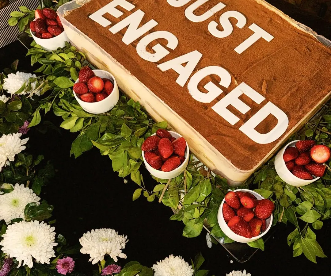 I love being a part of your special moments. This large-format Tiramisu was for a "Just Engaged" party, complete with fresh strawberries and flowers. We can customize our signature desserts to make your celebration even sweeter.
