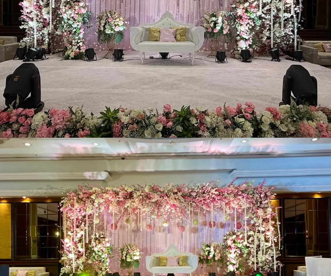 We love creating reception stages that feel like they are straight out of a fairytale. This design features a cascade of pink cherry blossoms, hanging floral strings, and soft lighting to create a deeply romantic and opulent setting for the couple's grand entrance.
