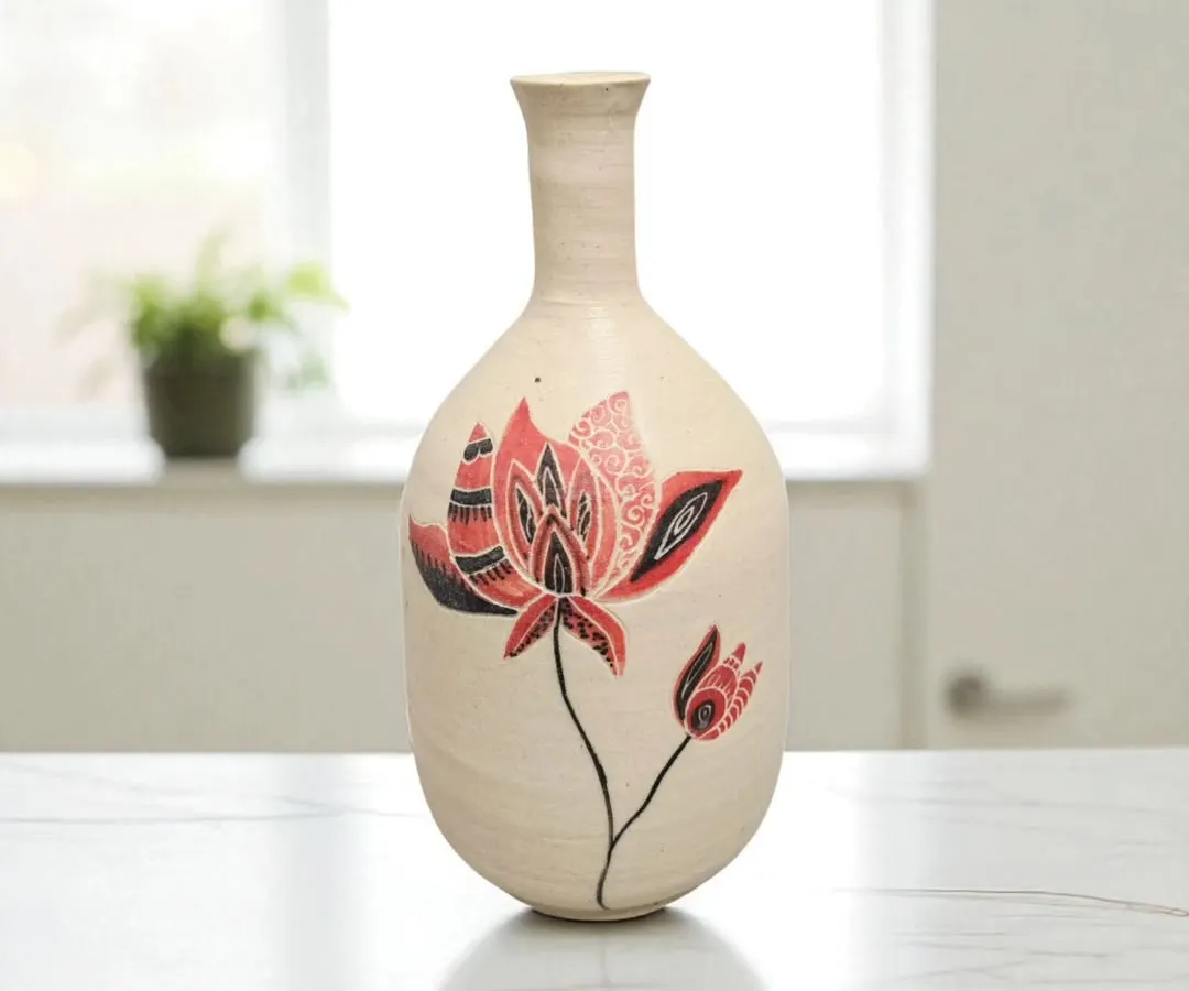 I shape and paint each ceramic vase by hand, making every piece one-of-a-kind. This vase, with its intricate red and black lotus design, brings a timeless warmth and artistry to any space, whether holding fresh flowers or standing alone.