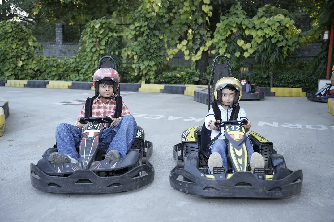 Ready, set, go! Our young racers gear up in their helmets and karts, prepared for a friendly competition on our specially designed kids' go-karting track.