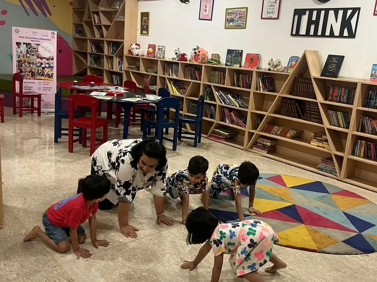 Learning is an adventure here. We were exploring basic physics concepts through a fun crawling game. I believe in play based learning where children use their whole bodies to understand new ideas and develop gross motor skills.