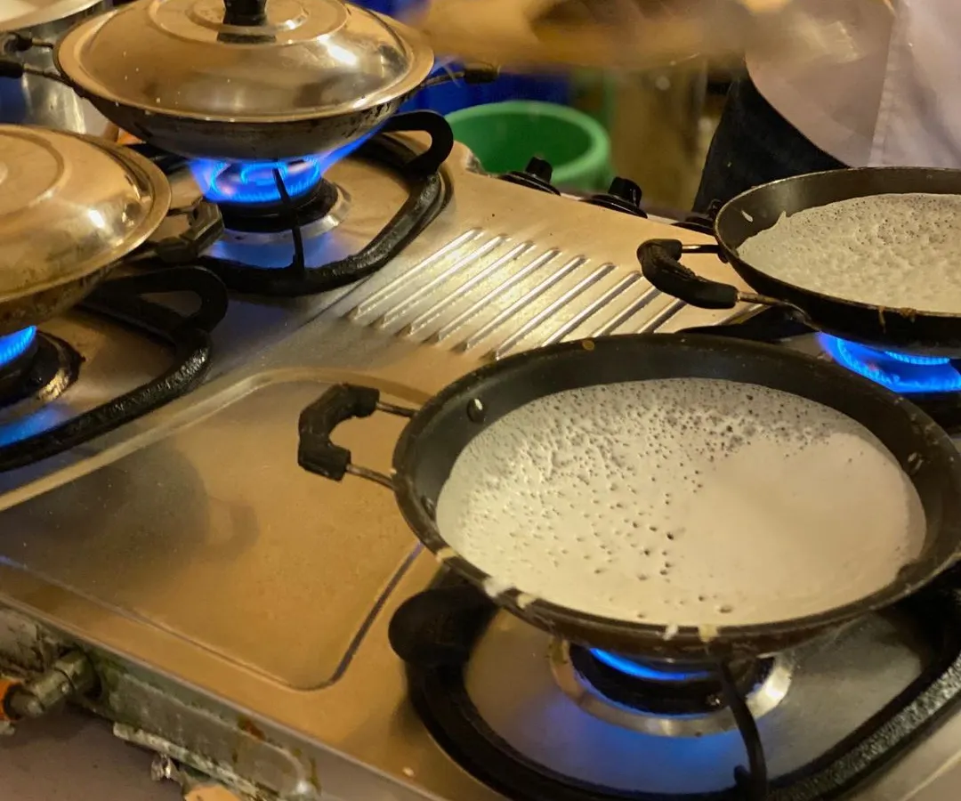 A glimpse of our live appam station in action. We bring the authentic taste of South Indian cuisine directly to your event, ensuring every serving is fresh, hot, and made right before your eyes.