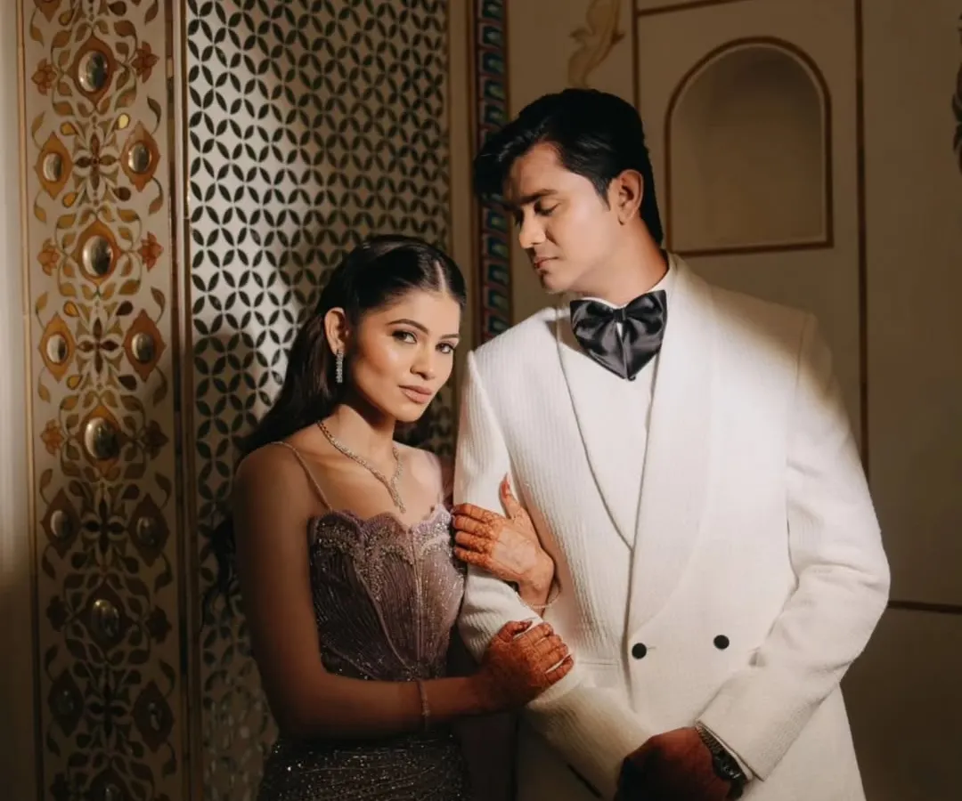 An elegant couple portrait from a royal sangeet in Ajmer. We focus on the connection between two people, using dramatic lighting and the regal backdrop of Pratap Mahal to create a timeless, editorial feel.