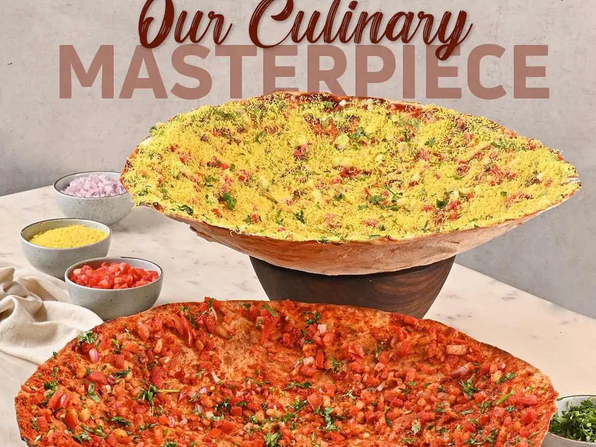 Meet my signature Kadak Roomali, a culinary masterpiece that's always a conversation starter. This giant, crispy flatbread is topped with fresh ingredients and is as impressive to look at as it is delicious to eat.