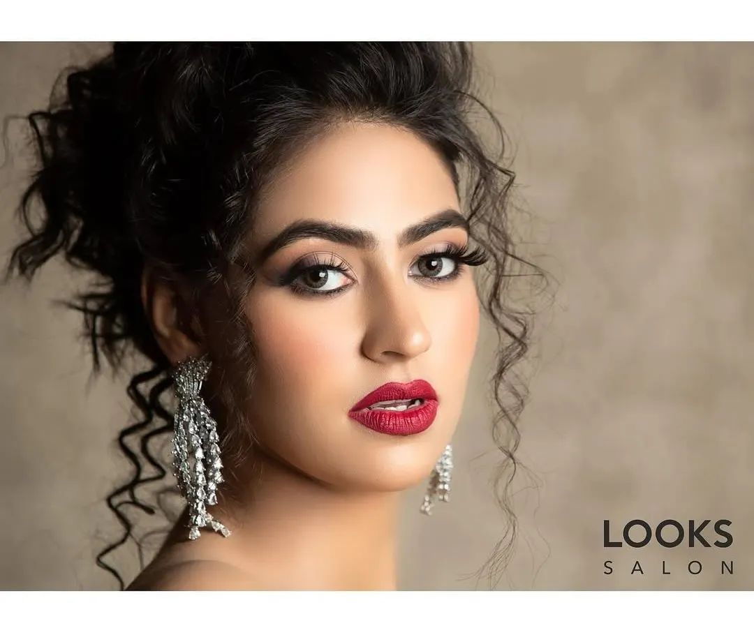 This is a classic glam party makeover, perfect for making a statement at any event. I created a bold red lip and defined eyes, paired with a sophisticated updo, to craft a look that is both powerful and elegant.