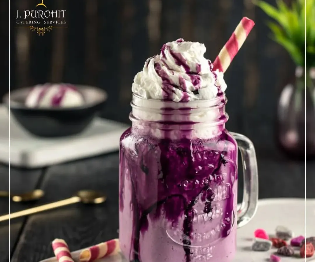 For those with a sweet tooth, I offer a range of dessert shakes that are both a drink and a treat. This Black Grape smoothie, served in a rustic mason jar, is topped with rich whipped cream and a colorful wafer straw. It's a popular choice for adding a fun and indulgent element to parties and family gatherings.