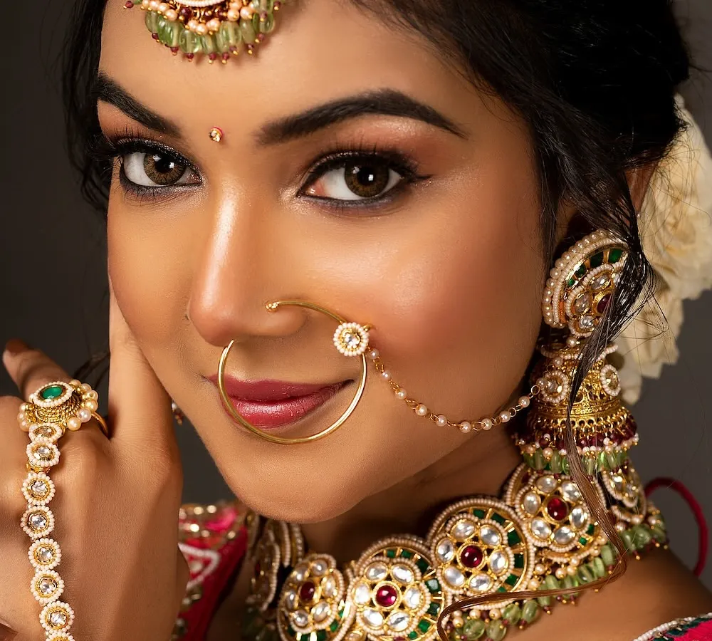 A close-up from a bridal portfolio shoot, focusing on the flawless makeup and intricate Kundan jewellery. I use lighting that makes the skin glow and brings out the richness of the traditional look.
