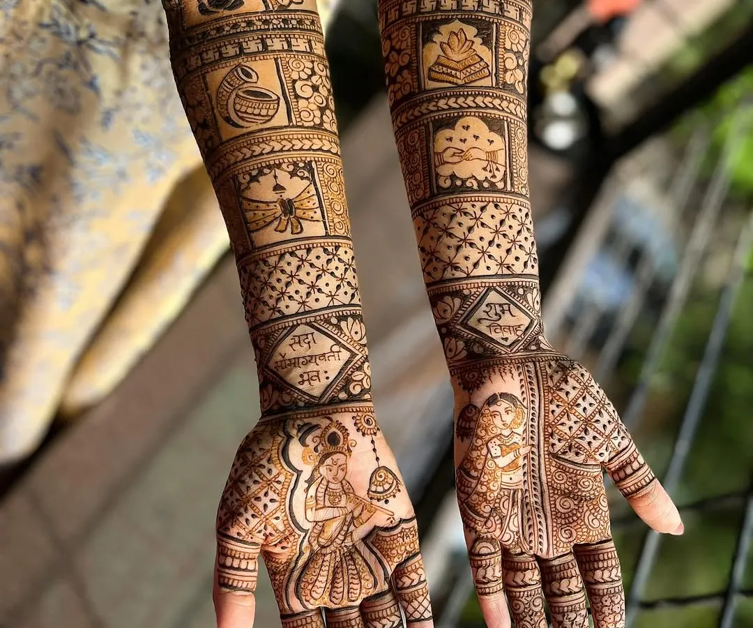 A masterpiece for a beautiful bride. This full bridal mehendi is a classic example of traditional design, filled with intricate patterns, portraits, and auspicious symbols like the kalash and Ganesha for a blessed beginning.