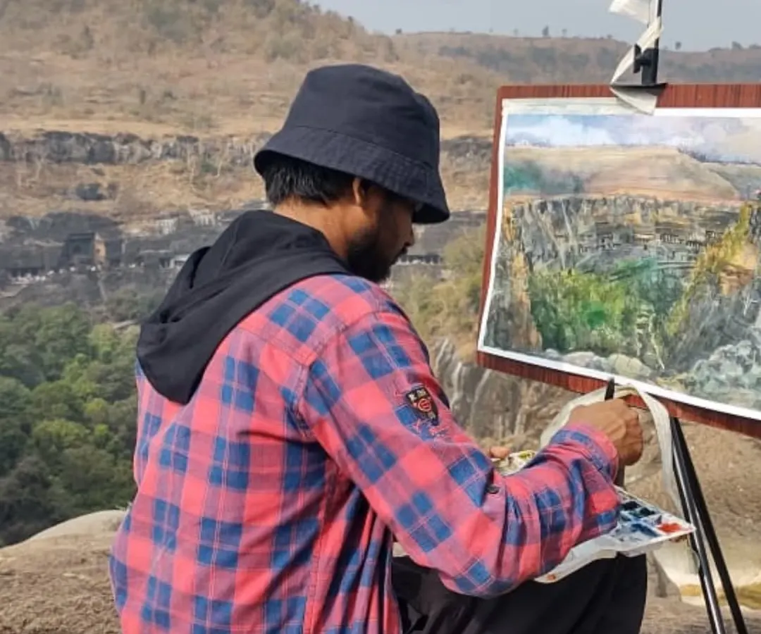 Here I am working on a watercolor painting, capturing the landscape from the Ajanta Caves viewpoint in Maharashtra. My studio is wherever I find inspiration, from bustling city streets to serene historical sites.