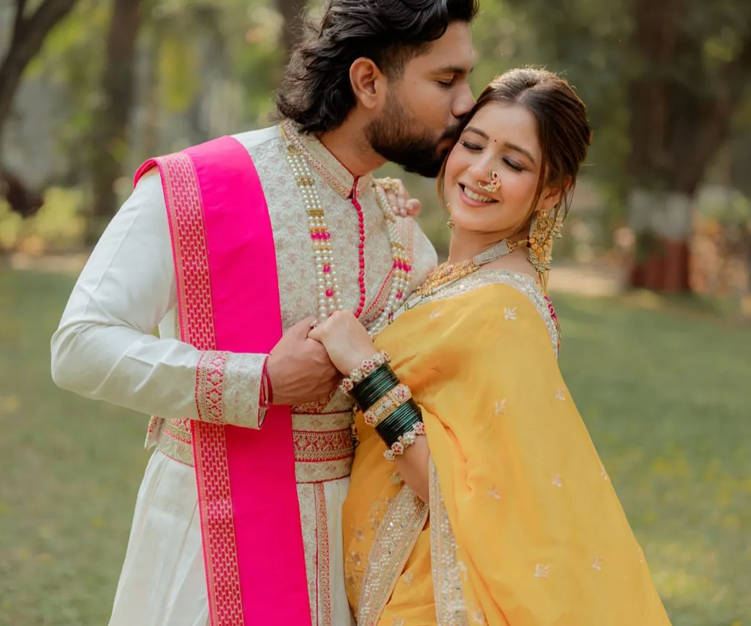 A tender moment from a traditional Marathi pre-wedding shoot. We focus on capturing the quiet connection between a couple, highlighting the richness of their heritage attire, like the groom's classic sherwani and the bride's vibrant yellow nauvari saree.